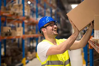 Movers handling office equipment and packed boxes during a business relocation.