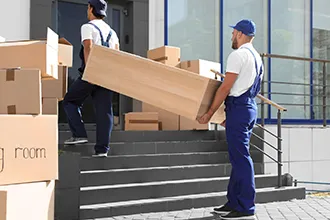 Boxes stacked on a moving cart, prepared for transport.