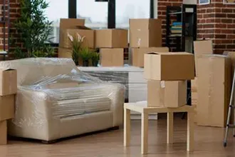 Packed boxes and furniture in a neatly arranged room.