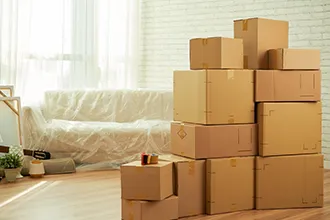 Stacked moving boxes in a modern office, representing local distance moving services.