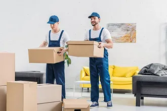 Professional packer holding a clipboard in a furnished home, showcasing packing services.