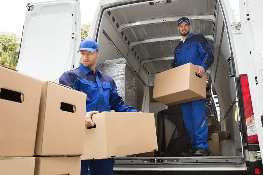 wo professional movers unloading cardboard boxes from a moving van in Edmond, OK.